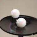 Elegant iridescent white ball stud earrings with a glossy finish on black display - Iridescent Sphere Style (E3530) / Rainbow