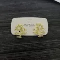 Intricately designed golden dragon shaped stud earrings on a white display card - Embossed Dragon Stud Earrings (E3719) / Gold Yellow