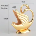 Elegant golden swan shaped napkin holder in zinc alloy with product dimensions 16x14cm - 14x16x4cm / L