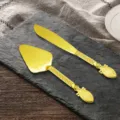 Elegant vintage golden cake knife and server set with ornate hollow-out handles for weddings - Phoenix Tail Style
