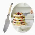 Premium stainless steel cake server with creamy white handle for elegant dessert serving - Cake Server Shovel / 1 Piece (OPP Bag)