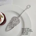 Vintage ornate silver-plated cake server with intricate floral engravings on white plate - Cake Spatula (7103S) / Silver