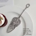 Vintage ornate silver-colored cake server with intricate floral carvings and heart handle - Cake Spatula (7103N) / Silver