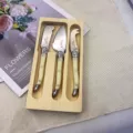 Stainless steel cheese knife set with creamy white handles and wooden box for butter and jam. - 3-Piece Set in Cream White with Wooden Box / Cheese Knife 3-Piece Set