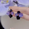 Macro view of elegant geometric purple crystal cube stud earrings featuring silver needles - Geometric Square Style (E3569) / Silver Purple