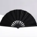 Elegante ventaglio pieghevole nero glitterato da 26 cm con stecche in plastica nera - Nero