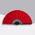 Vibrant red glitter 10-inch Kung Fu folding fan featuring durable black plastic ribs - Red