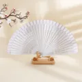 Elegante abanico plegable de madera blanca con rayas en un soporte de madera para danza - Blanco Crema