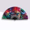 Large 33cm folding fan with vibrant psychedelic tie-dye pattern and black ribs - Neon