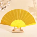 Ventaglio pieghevole con glitter oro da 7 pollici e stecche in plastica gialla, festa - 7" / Giallo