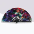 Handheld 33cm folding fan featuring a vibrant neon geometric pattern and black plastic ribs - Line