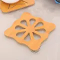 Hollow bamboo heat insulation coaster in natural wood finish for the kitchen table - Square Plum