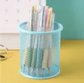 Blue hollow mesh metal pen holder for desk storage with colorful gel pens. - Round Light Blue