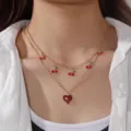 Elegante collana dorata a doppio strato con ciondoli a ciliegia rossa e cuore scintillante - Modello a doppio strato con ciliegia e cuore / 02 Oro