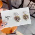 Detailed view of heart-shaped stud earrings encrusted with sparkling rhinestones - Heart (E0083) / White