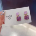 Detailed close-up of purple enamel square earrings with sparkling rhinestones on display - Square (E0083) / Purple