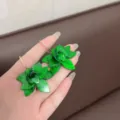 Detailed close-up view of green flower hoop earrings with elegant marble texture petals - E4018 Green Hoops / Green