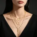 Detailed view of layered gold cross pendant necklaces with pearl accents on elegant model - Coin and Pearl Cross Style / Gold
