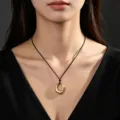 Close-up of a minimalist gold geometric pendant necklace worn on a black cord. - Black Cord Style (03) / Gold