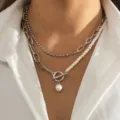 Layered silver-tone chain necklace featuring a baroque pearl pendant and OT clasp detail. - Pearl Layered OT Clasp Teardrop Necklace / Silver
