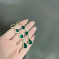 Close-up of elegant emerald green crystal drop earrings with gold-toned rhinestone accents - Crystal Tassel Style (E3032) / Gold Green
