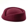 Close-up of a vintage burgundy wool felt pillbox hat for flight attendant style - Burgundy