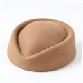 Close-up of a vintage brown felt pillbox stewardess hat showing smooth texture - Khaki