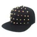 Detailed view of the gold conical spikes on the black hip-hop snapback hat. - Adjustable / Gold Rivets
