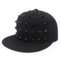 Close-up detail of black hip-hop snapback hat with decorative punk spikes - Adjustable / Black With Rivets