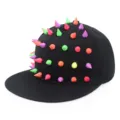 Detail view of black snapback hat with multi-colored punk style cone spikes - Adjustable / Colored Rivets