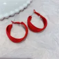 Close-up of red multi-layered hoop earrings with a matte finish on white texture. - Multi-layer Circle Style (E0984) / Red