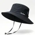 Close-up detail of a black wide brim sun hat showing breathable mesh and chin strap - One Size / Black