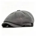 Detailed view of a classic grey herringbone newsboy cap with vintage octagonal design - One Size / Off-White
