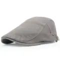 Close-up side view of a classic grey cotton twill flat cap featuring an adjustable metal buckle - Gray