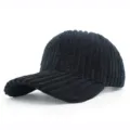 Detailed texture view of a black thick corduroy baseball cap with a curved brim. - Adjustable / Black