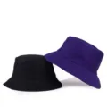 Minimalist solid color reversible bucket hats in black and purple for outdoor sun protection - One Size / Reversible / Purple/Black