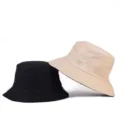 Minimalist reversible bucket hats in black and beige for casual outdoor sun protection. - One Size / Reversible / Khaki/Black