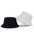 Minimalist reversible solid color canvas bucket hats available in black and white set - One Size / Reversible / White/Black