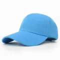 Detailed view of a solid light blue blank baseball cap featuring a curved brim. - 56-58cm (Adjustable) / Lake Blue