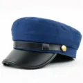 Close-up of navy blue fiddler cap with black leather brim and gold metal button - M (56-58cm) / Blue