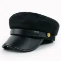 Detailed view of a black newsboy baker boy hat with a leather brim and gold buttons - M (56-58cm) / Black