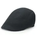 Close-up view of the side profile and fabric texture of a black cotton flat cap. - One Size / Black