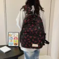 Stylish large capacity black backpack with red bow patterns for students and travel - Red