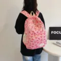 Cute pink high-capacity school backpack featuring red bow patterns for students - Rose Red