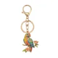 Colorful parrot keychain with sparkling rhinestones perched on a flowering branch - Red