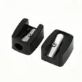 Macro view of two mini black single-hole sharpeners for eyebrow and lip makeup pencils - Single Piece / Black