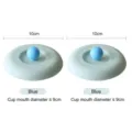 Set of two light blue 10cm food-grade silicone cup lids featuring round spherical handles - 10cm Size / Blue