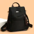 Stylish black anti-theft backpack with brown tassels and gold-tone hardware detail - L / Black and Brown