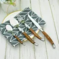 Detailed view of Laguiole-style stainless steel cutlery with ergonomic wooden handles. - 4-Piece Knife Fork Spoon Set