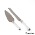 Close-up detail of crystal-filled handles on silver cake knife and server set for weddings - Two-Piece Set / White